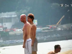 Topless beauty in tiny thong on beach camera