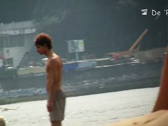 Topless beauty in tiny thong on beach camera