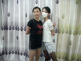 Two Chinese Girls Tied, One Wearing Cloth Mask
