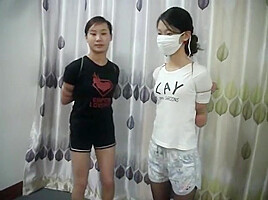 Two Chinese Girls Tied, One Wearing Cloth Mask