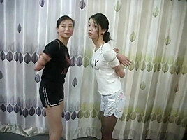 Two Chinese Girls Tied, One Wearing Cloth Mask