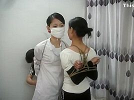 Two Chinese Girls Tied, One Wearing Cloth Mask