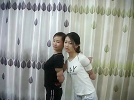 Two Chinese Girls Tied, One Wearing Cloth Mask