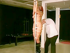 Woman Stands With Her Tits Bound Up In Sexy Slavery Scenes