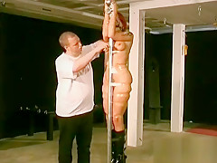 Woman Stands With Her Tits Bound Up In Sexy Slavery Scenes