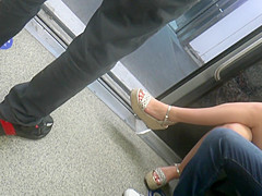 Young brunette, sexy legs in wedges heels