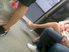 Young brunette, sexy legs in wedges heels