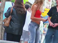 candid skinny tanned ad girl standing on the street in tight clothes
