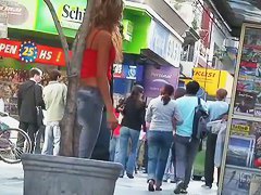 candid skinny tanned ad girl standing on the street in tight clothes