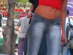 candid skinny tanned ad girl standing on the street in tight clothes