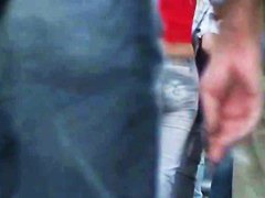 candid skinny tanned ad girl standing on the street in tight clothes