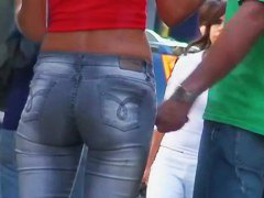 candid skinny tanned ad girl standing on the street in tight clothes